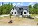 Charming home with white siding, black trim, and well-manicured landscaping in a beautiful tree-filled neighborhood at 320 Pilot Ridge Rd, Zebulon, NC 27597