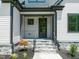 Elegant front porch with stone stairs and black metal railings welcomes you to this meticulously maintained home at 320 Pilot Ridge Rd, Zebulon, NC 27597