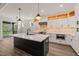 Stylish kitchen featuring a large island, quartz countertops, herringbone backsplash, and stainless steel appliances at 320 Pilot Ridge Rd, Zebulon, NC 27597