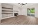 The living room has a fireplace, shelves, and a sliding door that leads to a deck at 320 Pilot Ridge Rd, Zebulon, NC 27597