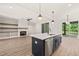 Open floor plan connecting the kitchen and living room with a fireplace, built-in shelving, and outdoor access at 320 Pilot Ridge Rd, Zebulon, NC 27597