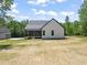 Back of house featuring a screened-in porch and a spacious, green yard at 320 Pilot Ridge Rd, Zebulon, NC 27597