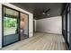 Relaxing screened porch with wood flooring, ceiling fan, and view into the house at 320 Pilot Ridge Rd, Zebulon, NC 27597