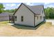 Side view of the house with a well-maintained lawn and dark trim windows at 320 Pilot Ridge Rd, Zebulon, NC 27597