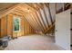 Unfinished room featuring wooden beams, a window, and natural light at 320 Pilot Ridge Rd, Zebulon, NC 27597