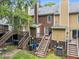 Backyard view of several townhouses with decks and staircases from an elevated position at 4541 Hershey Ct, Raleigh, NC 27613