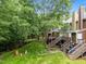 Backyard view featuring lush greenery, decks, stairs, and the back exterior of the multi-story home at 4541 Hershey Ct, Raleigh, NC 27613