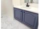 Bathroom vanity featuring blue cabinets, white countertop, and modern fixtures at 4541 Hershey Ct, Raleigh, NC 27613