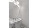 Elegant bathroom with a pedestal sink, brushed nickel fixtures, and a round mirror at 4541 Hershey Ct, Raleigh, NC 27613