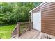 View of deck with brown wooden railings and a white door leading to the home's exterior at 4541 Hershey Ct, Raleigh, NC 27613