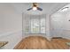 Bright dining area featuring wood floors, bay window, and ceiling fan with traditional decor at 4541 Hershey Ct, Raleigh, NC 27613