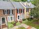 Aerial view of well-maintained townhomes with manicured lawns and mature trees, boasting classic architectural details at 4541 Hershey Ct, Raleigh, NC 27613