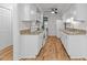 Efficient kitchen showcasing white cabinets, granite countertops, modern appliances, and wood flooring at 4541 Hershey Ct, Raleigh, NC 27613