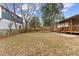 Large backyard with a wooden fence and mature trees at 504 Branch St, Raleigh, NC 27601