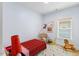 Bright bedroom with plaid bedding, rocking chair, and playful decor at 504 Branch St, Raleigh, NC 27601