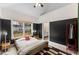 Bedroom with wood bed frame and access to bathroom at 504 Branch St, Raleigh, NC 27601