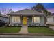Charming craftsman style home with gray siding and a bright yellow front door at 504 Branch St, Raleigh, NC 27601