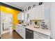 Bright kitchen boasts white cabinets, quartz countertops and a yellow accent wall at 504 Branch St, Raleigh, NC 27601