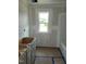 Bathroom with a window, vanity, and tub awaiting finishing touches, ideal for relaxation at 53 Priming Way, Angier, NC 27501