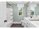 Modern bathroom with white vanity, bathtub, and gray floor at 53 Priming Way, Angier, NC 27501