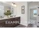 Double sink bathroom featuring dark wood cabinets, large mirror, and stylish artwork at 53 Priming Way, Angier, NC 27501