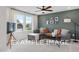Bright bonus room with sectional sofa and large windows at 53 Priming Way, Angier, NC 27501
