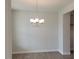 Dining room features modern chandelier and neutral color palette, perfect for entertaining at 53 Priming Way, Angier, NC 27501