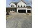 Exterior view of a home under construction, featuring large windows and an attached two-car garage at 53 Priming Way, Angier, NC 27501