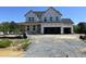 New two-story home showcasing a modern architectural style in the early stages of construction with a visible gravel driveway at 53 Priming Way, Angier, NC 27501