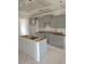 An unfinished kitchen with light grey cabinets, awaiting countertops, and other finishing touches at 53 Priming Way, Angier, NC 27501