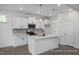 Modern kitchen with white cabinets and a large island at 53 Priming Way, Angier, NC 27501