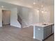 Open-concept kitchen with modern island that flows into the adjacent living space at 53 Priming Way, Angier, NC 27501