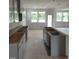 Spacious kitchen area with light grey cabinets and large windows for natural light at 53 Priming Way, Angier, NC 27501