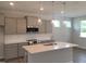 Modern kitchen with stainless steel appliances, a quartz island, and pendant lighting at 53 Priming Way, Angier, NC 27501