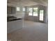 Open kitchen area with light grey cabinets and large windows, awaiting final touches at 53 Priming Way, Angier, NC 27501