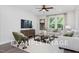 Comfortable living room with light-colored sofa and large windows at 53 Priming Way, Angier, NC 27501