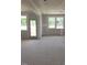 Bright living room showing door to deck and several windows offering backyard views at 53 Priming Way, Angier, NC 27501
