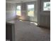 Bright living room featuring drywall and windows letting in natural light, ready for your personal touch at 53 Priming Way, Angier, NC 27501