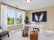 Bright office space with a large window, a white desk, and stylish ottomans for a modern look at 53 Priming Way, Angier, NC 27501