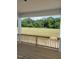 Inviting porch with wood-plank flooring and a scenic view of the surrounding field and lush greenery at 53 Priming Way, Angier, NC 27501