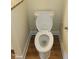 White toilet in a clean bathroom with wood-look flooring at 5409 Crescentview Pkwy, Raleigh, NC 27606