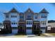 Charming townhome featuring brick facade, private garages, and covered entryways for comfortable and stylish living at 5409 Crescentview Pkwy, Raleigh, NC 27606