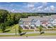 Wide shot of townhome community, highlighting the street and surrounding landscape at 705 Traditions Grande Blvd, Wake Forest, NC 27587