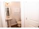 Small bathroom with pedestal sink, toilet and wall cabinet at 705 Traditions Grande Blvd, Wake Forest, NC 27587
