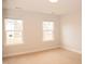 Bright bedroom with carpet and two large windows at 705 Traditions Grande Blvd, Wake Forest, NC 27587
