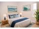 Coastal-themed bedroom with white bedding and ocean artwork at 705 Traditions Grande Blvd, Wake Forest, NC 27587