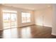 Spacious living room featuring hardwood floors and access to a deck at 705 Traditions Grande Blvd, Wake Forest, NC 27587