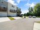 Townhomes showcasing rear garages, decks, and parking area at 705 Traditions Grande Blvd, Wake Forest, NC 27587