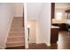 Carpeted staircase with kitchen and entryway views at 705 Traditions Grande Blvd, Wake Forest, NC 27587