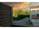 View from balcony of street, garage, and adjacent home with a colorful sky at 705 Traditions Grande Blvd, Wake Forest, NC 27587